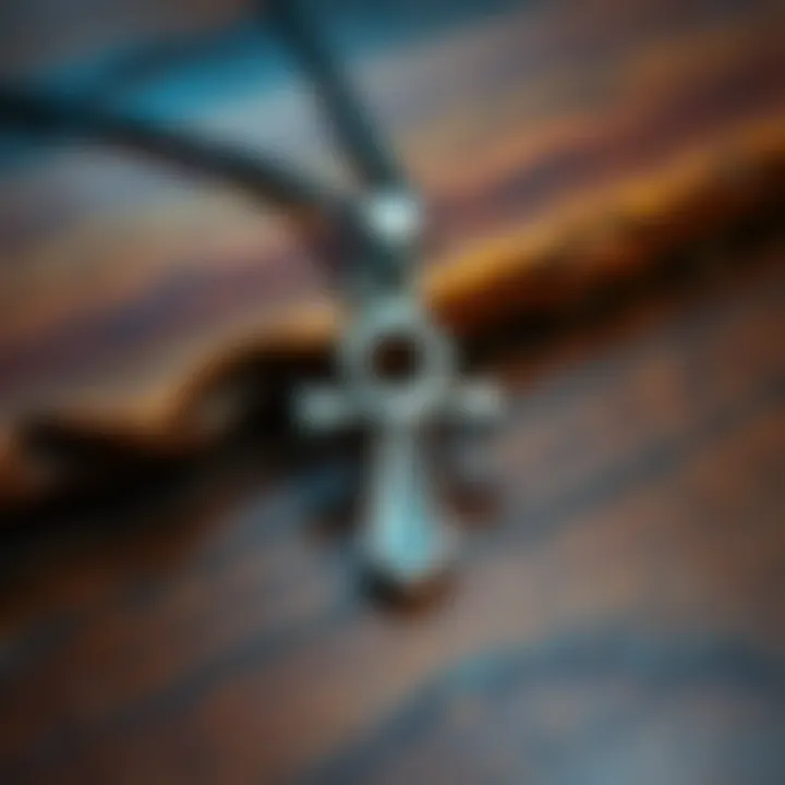 A close-up of a silver Ankh symbol pendant on a wooden surface, representing devotion to Lady Bastet.