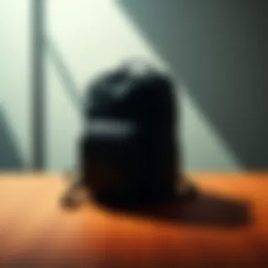 A closed backpack sitting on a wooden table, casting a shadow.