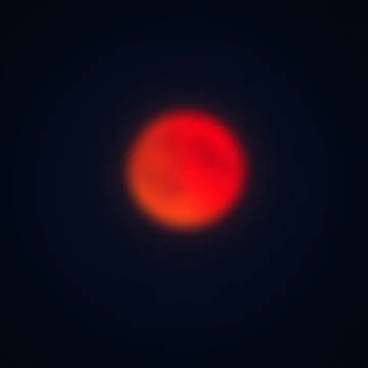 A bright red blood moon shining in a clear night sky with stars.