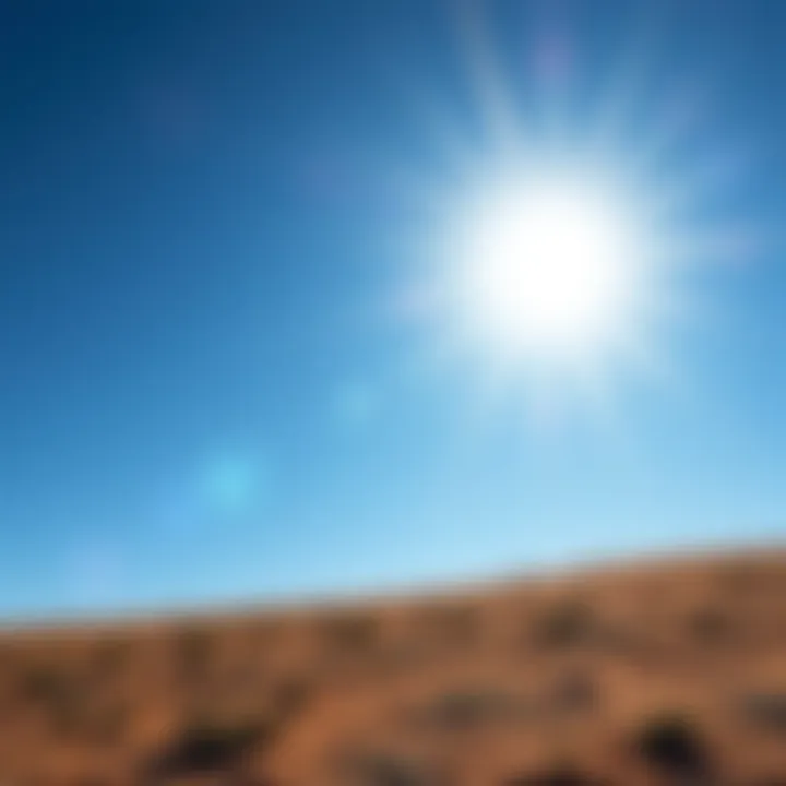 A bright sun shining in a clear blue sky, casting strong rays of light on the ground.