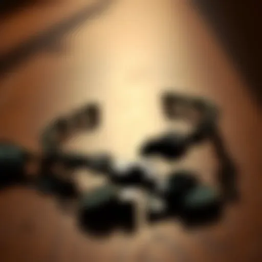 A close-up of a broken evil eye bracelet resting on a wooden table, with a hint of sunlight reflecting off the pieces