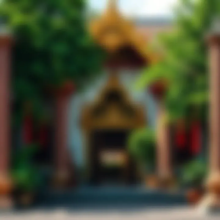 Buddhist temple entrance A serene entrance of a Theravada Buddhist temple with decorative banners and lush greenery.