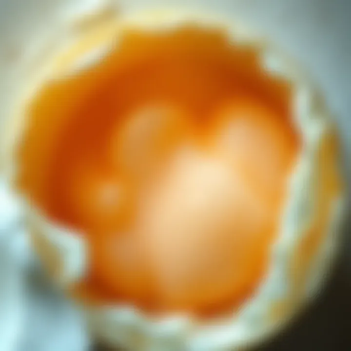 A close-up of a cloudy yolk in an egg, symbolizing emotional struggles and health changes. The yolk appears murky, contrasting with a clear egg white.