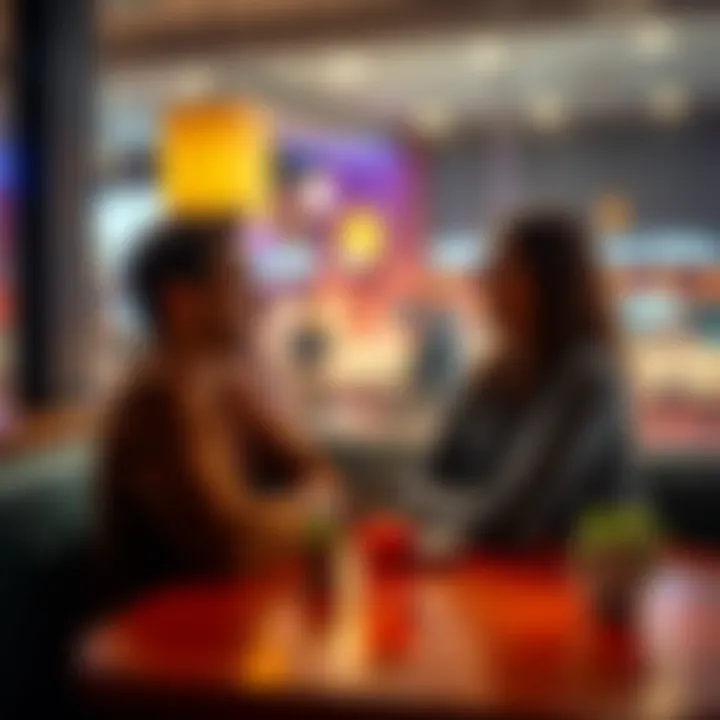 Couple Sitting Across From Each Other A man and woman sitting across from each other at a restaurant table, both smiling and looking at each other, suggesting a connection and interest.