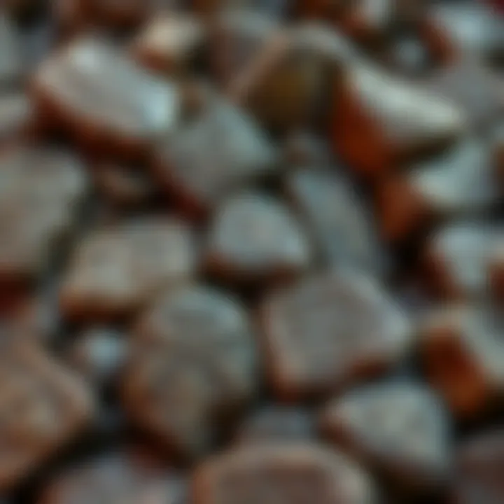 A collection of finished Elder Futhark rune stones made from natural rocks, showcasing unique symbols carved into their surfaces.