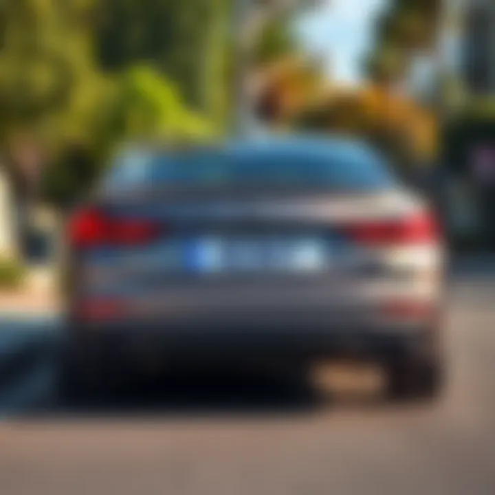 A customized license plate that spells a unique name, parked in a sunny street.