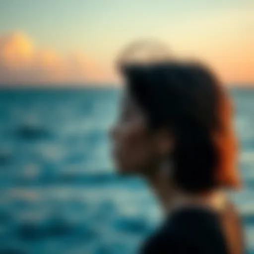 A person with a thoughtful expression gazes at the ocean, reflecting on deep emotions and relationships, symbolizing the impact of hurt