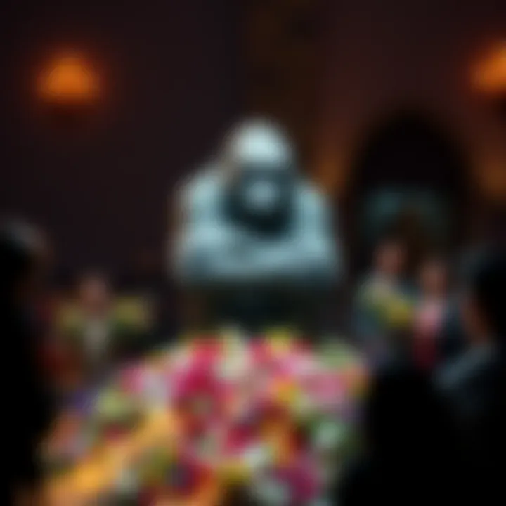 A memorial statue of Harambe the gorilla surrounded by flowers and candles, with people gathered to pay their respects.