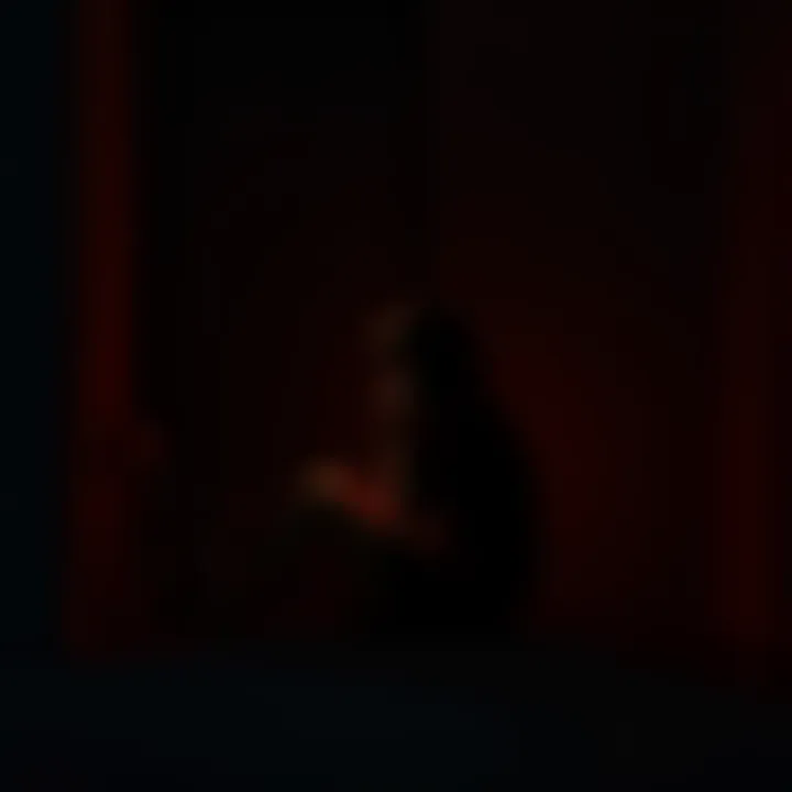 A person sitting alone in a dimly lit room, looking sad and contemplative, representing the pain of twin flame rejection.
