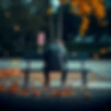 A person sitting on a park bench with their head down, looking sad after a breakup, with autumn leaves falling around them