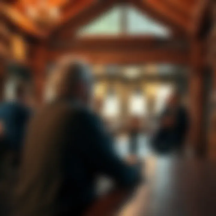 A lodge member sitting alone at a table, looking contemplative in a cozy lodge setting, with a few other members chatting in the background.