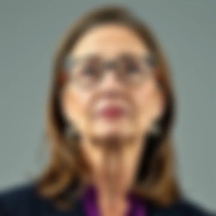 Close-up portrait of Melinda Gates looking thoughtful with a neutral background
