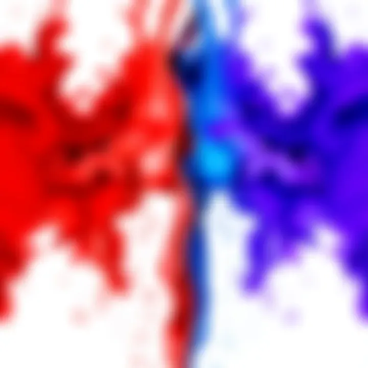 Two paint splashes, one red and one blue, blending together to form purple.