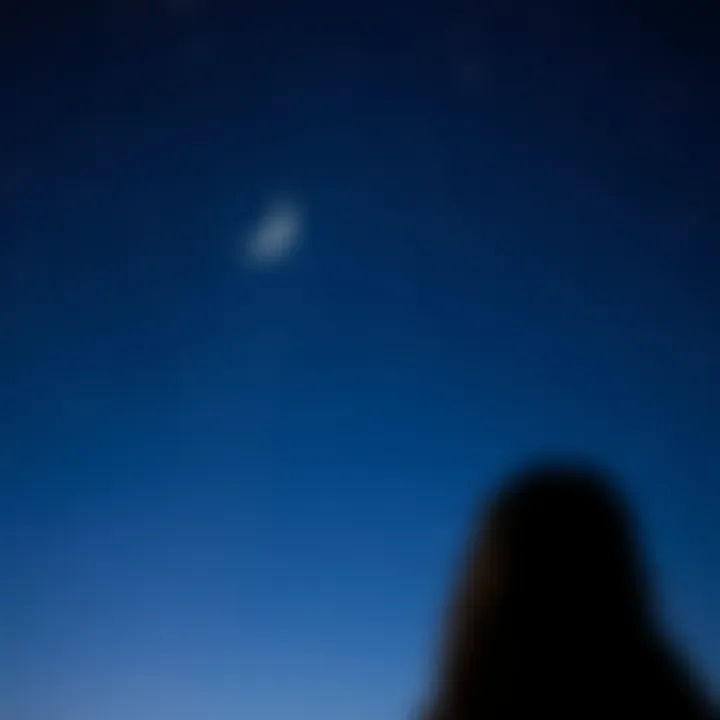 Moon Sign and Social Connections A person looking at a starry night sky with a crescent moon, symbolizing moon signs and friendships.