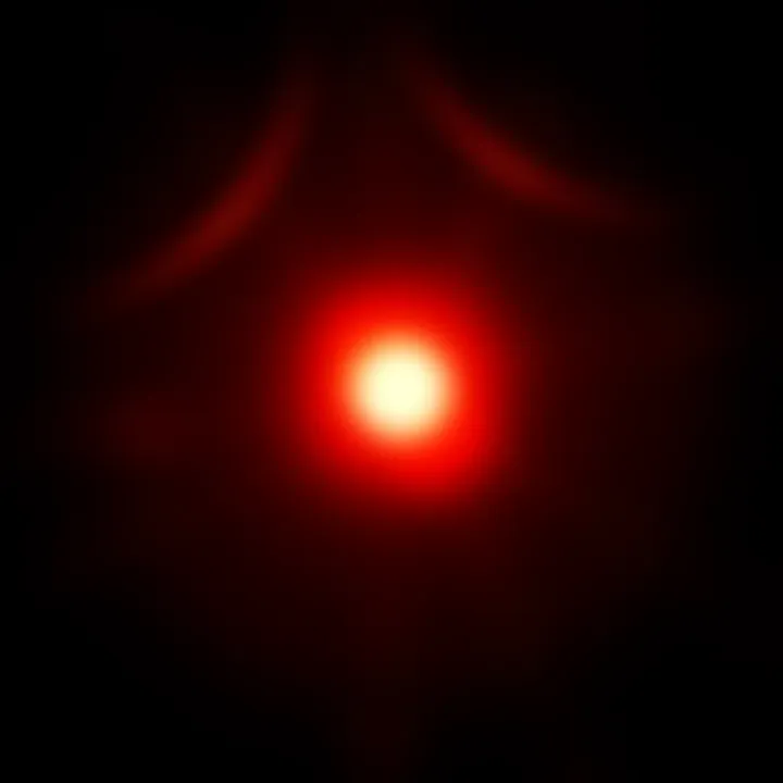 Close-up of a glowing dot surrounded by dark shadows, symbolizing curiosity and suspense in a popular TV series.