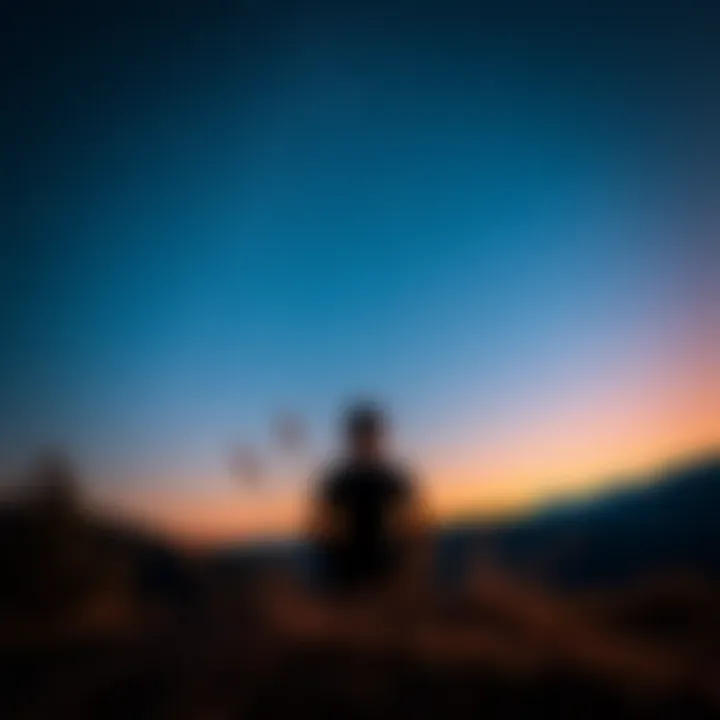 A person sitting on a hill, looking up at a clear starry night sky, reflecting feelings of sadness and longing
