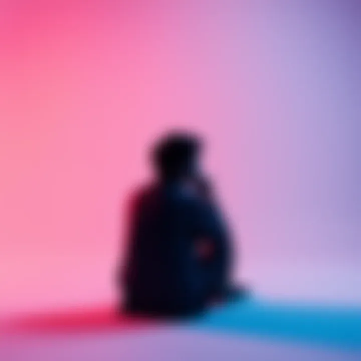 Person contemplating identity A person sitting alone, deep in thought, with a blank background symbolizing introspection about identity.