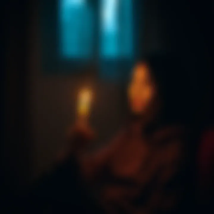 A person sitting in a dimly lit room, holding a lit candle with a thoughtful expression, symbolizing the desire to connect with departed loved ones.