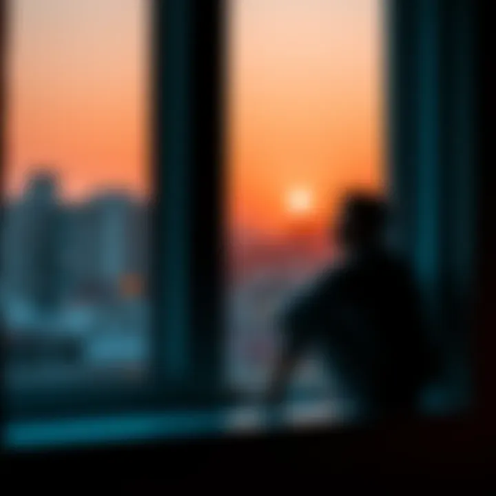 Individual sitting by a window, looking contemplative with a distant gaze, symbolizing heartbreak and reflection on a past relationship.