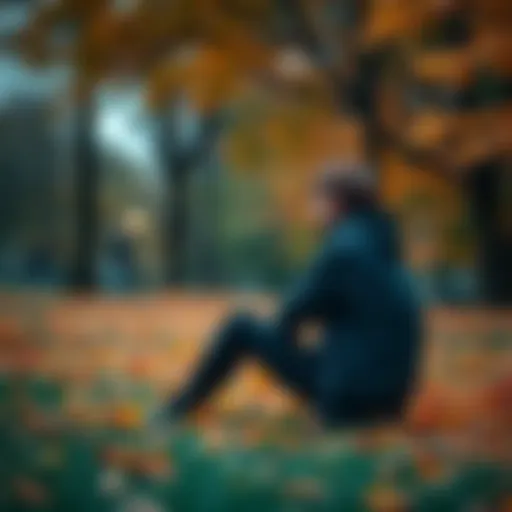 Individual sitting alone in a park, deep in thought, surrounded by fallen leaves, symbolizing overcoming struggles.