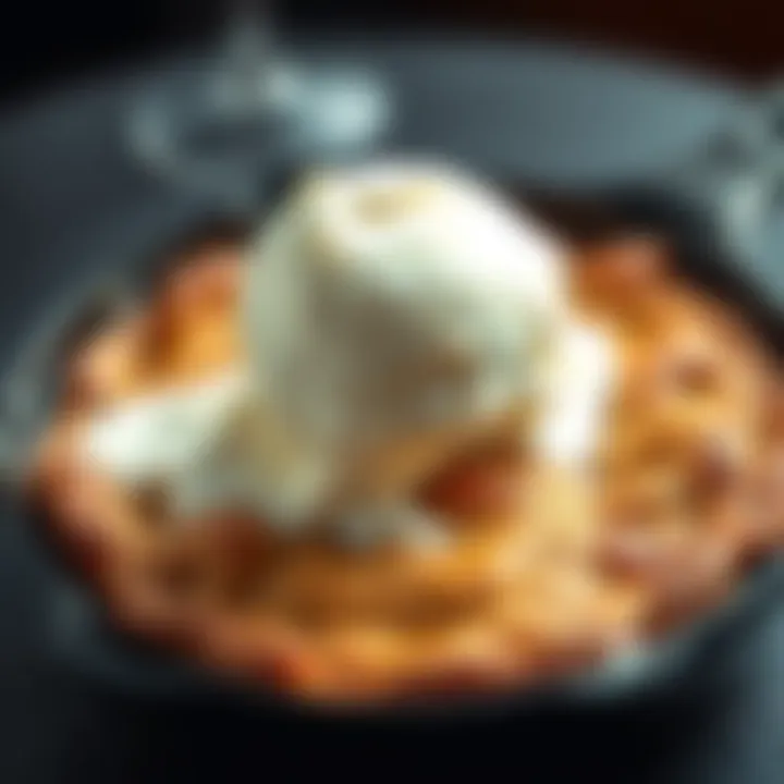 A warm pizookie served in a skillet with a scoop of vanilla ice cream melting on top