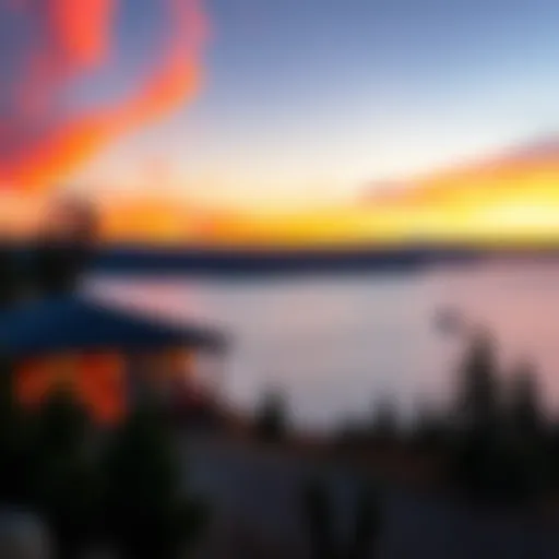 View of Port McNeil Lodge with the ocean and trees at sunset