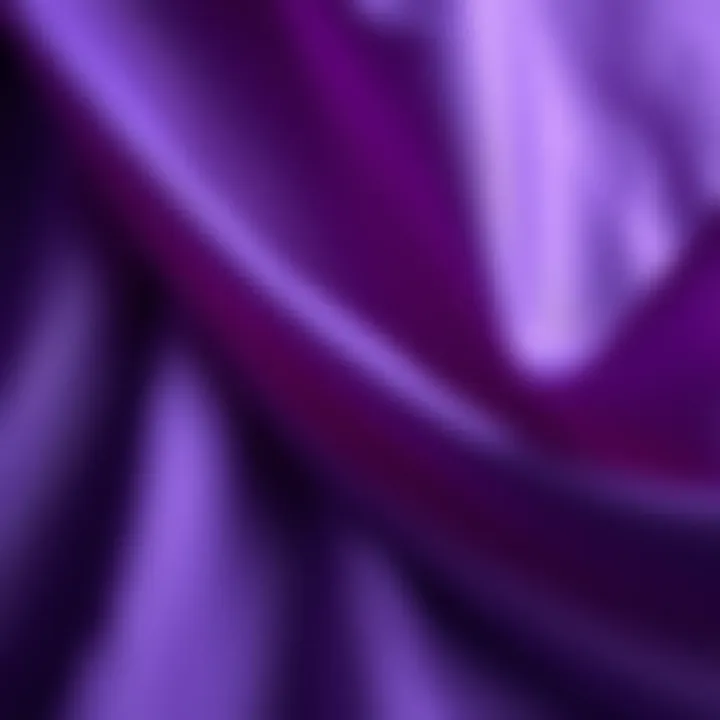 A close-up of rich purple fabric flowing gracefully, symbolizing royalty and creativity, with soft light highlighting its texture.