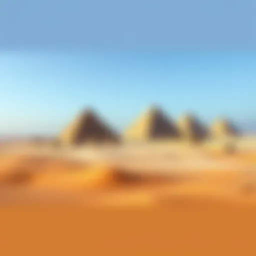 Aerial view of the Pyramids in Egypt, surrounded by sandy terrain and clear blue sky.
