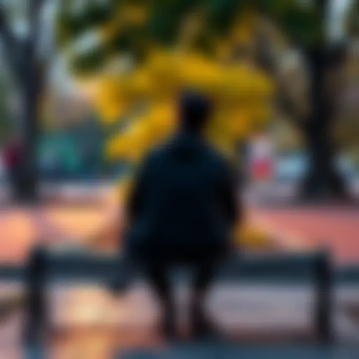 Reflecting on Past Relationships A person sitting alone on a park bench, looking thoughtful while their phone rests beside them, symbolizing emotional detachment from past relationships.