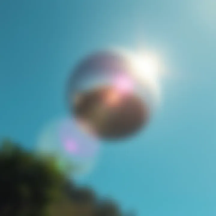 Silver Orb in Colombia Sky A shiny silver orb floating silently in the clear blue sky over Colombia, with no visible propulsion, observed by witnesses below.