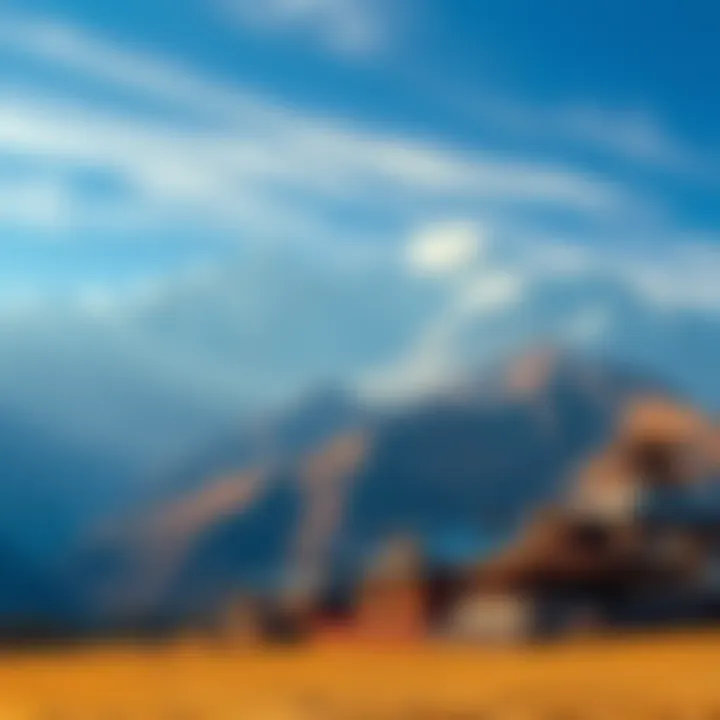 A breathtaking view of snow-capped mountains in Tibet with traditional Tibetan houses in the foreground.