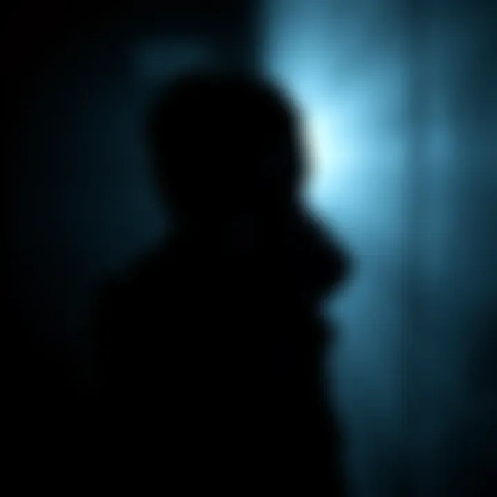 A person in a dark room looking worried, symbolizing the fear of speaking out against corruption.