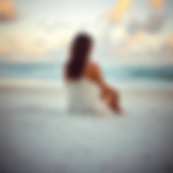 A woman sits alone on a sandy beach in Puerto Rico, looking contemplative with the ocean waves in the background.