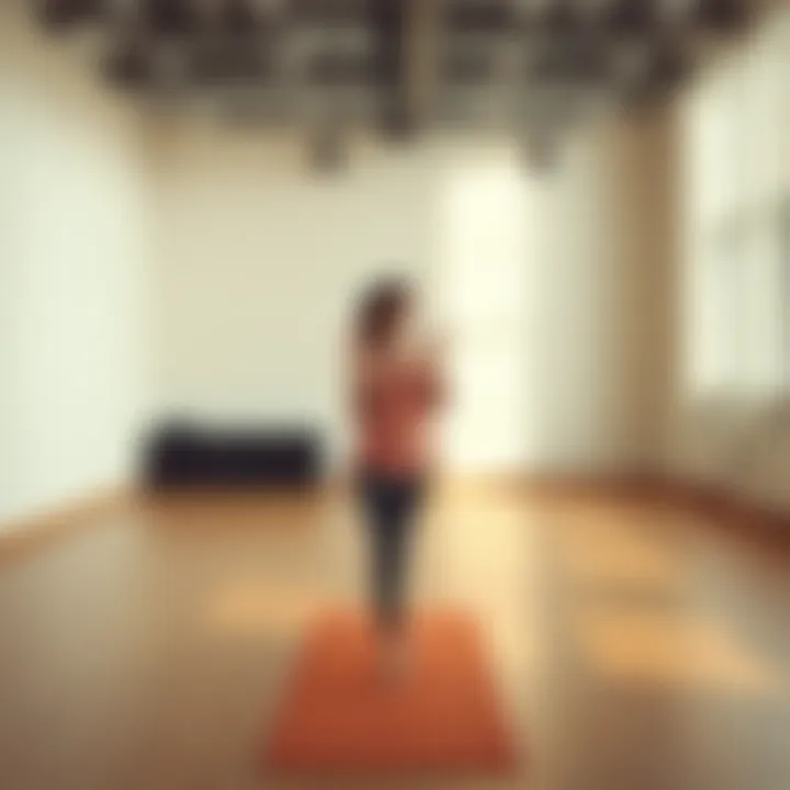 A yoga teacher stands on a mat in an empty studio, looking disappointed as she reflects on losing her class due to low attendance.