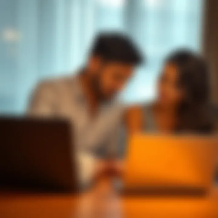 A young couple discussing their career and marriage while sitting at a table with a laptop and wedding rings in view