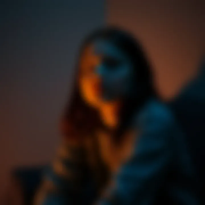 An 18-year-old woman with a worried expression sits alone in a dimly lit room, reflecting her struggle with mental health and feelings of anxiety.