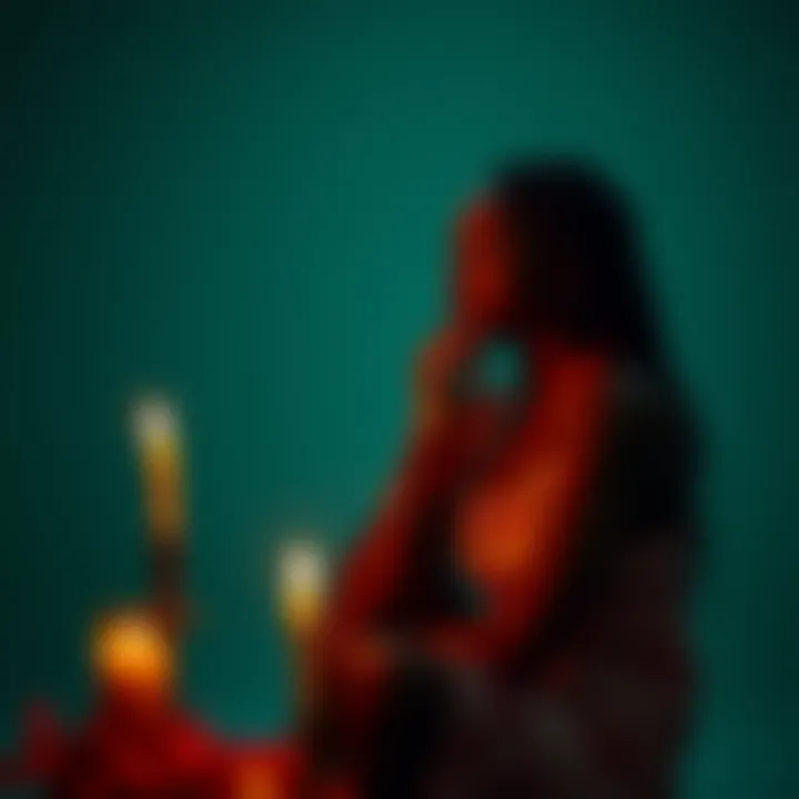 A 19-year-old woman sits by a candle, deep in thought, symbolizing her spiritual journey and connection to Vodou.